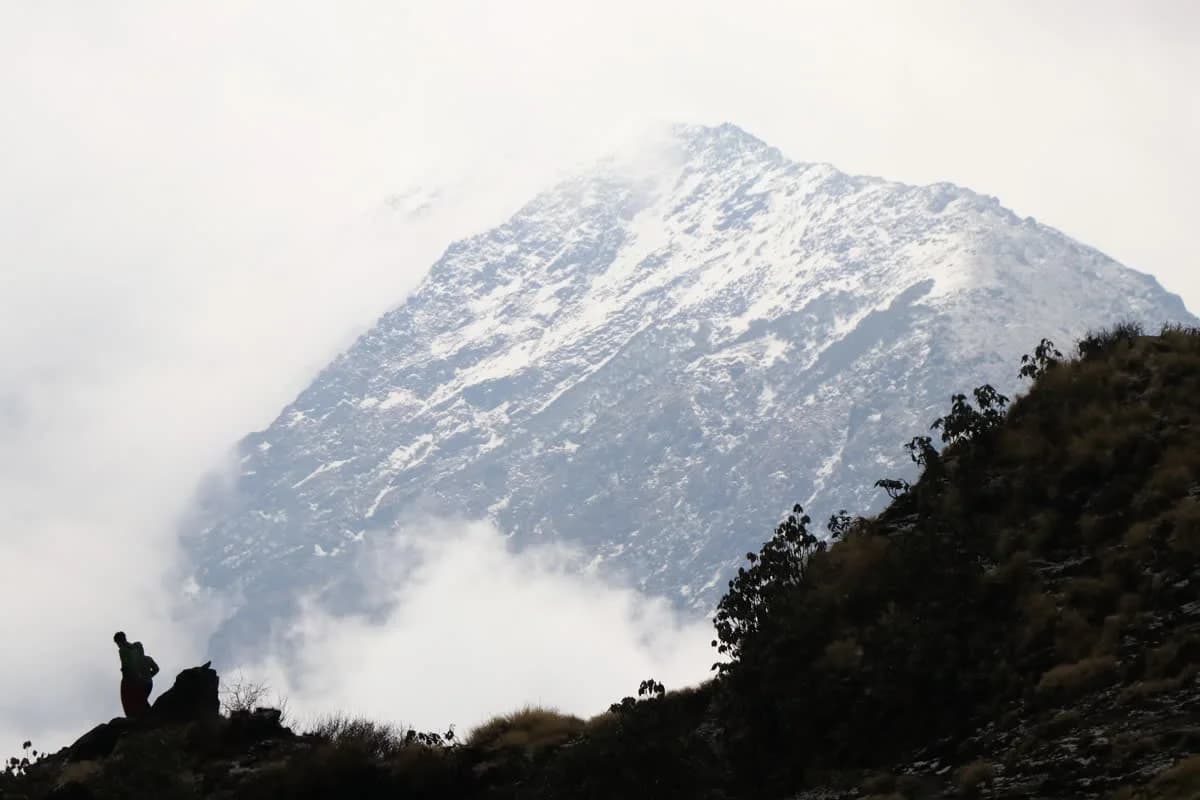 A trekker on the ridge above Mardi Himal High Camp at first light